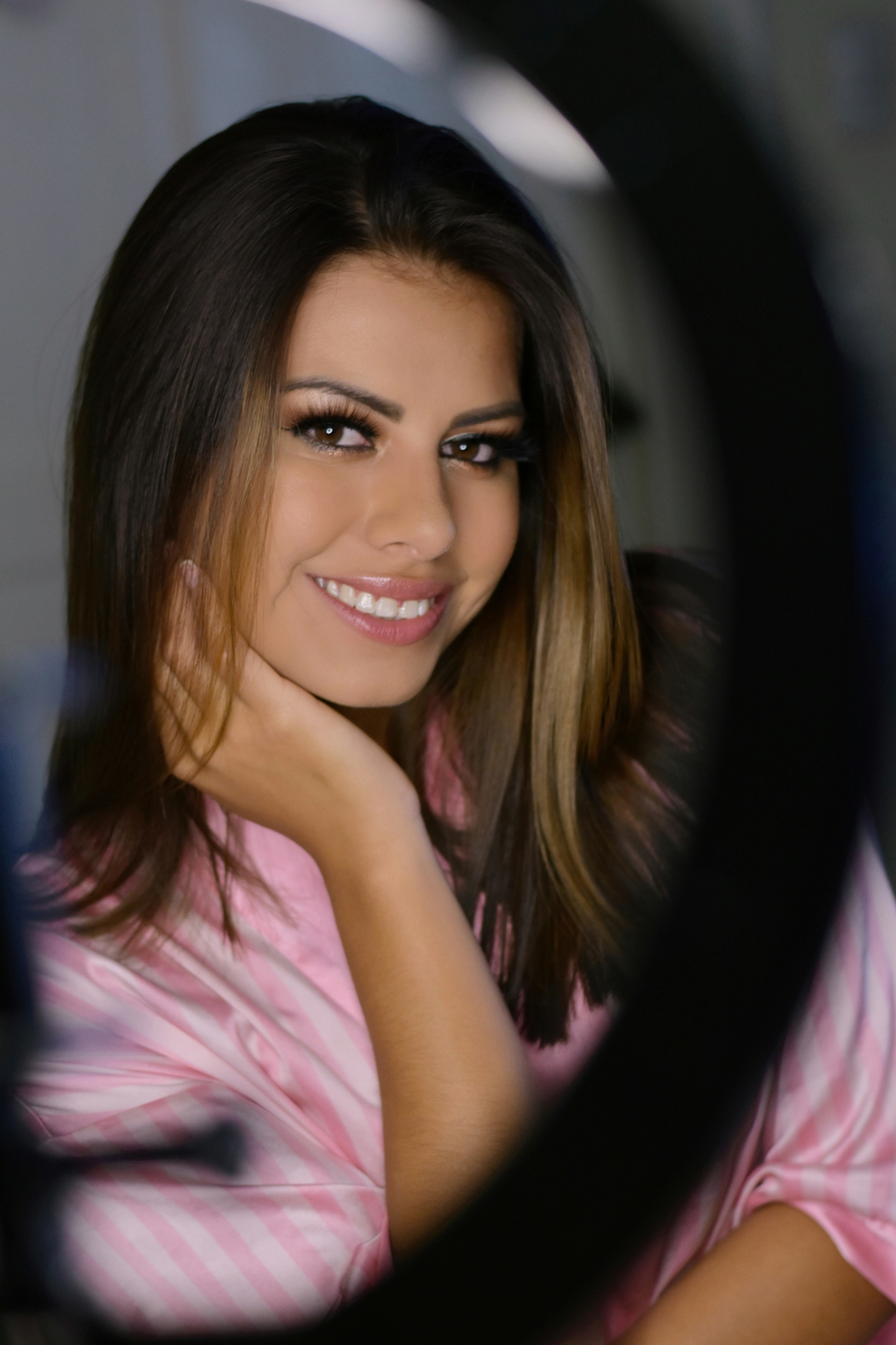 woman in pink and white stripe shirt smiling